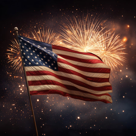 The American flag waves as fireworks burst in the night sky, celebrating freedom.の素材