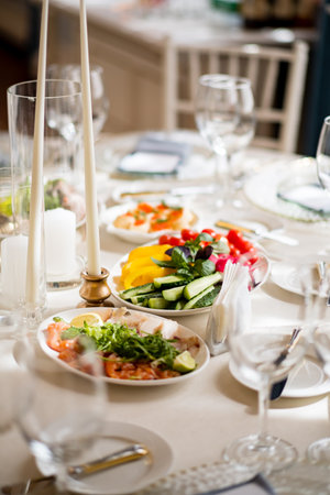 A stunning table showcases fresh salads and vibrant dishes, perfect for a festive gathering.の写真素材