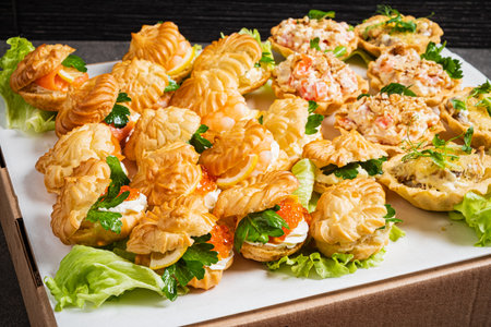 Savory and sweet pastry bites entice guests at a lively afternoon gathering.の写真素材