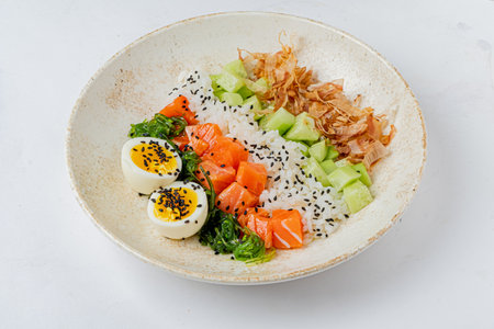 A colorful bowl featuring fresh salmon, vegetables, and garnishes for a delightful meal.の写真素材