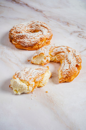 Soft, flaky pastries dusted with powdered sugar offer a tempting treat for dessert lovers.の写真素材