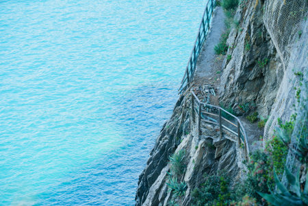 Winding along the rocky cliffs, the path offers stunning views of the clear turquoise waters below.