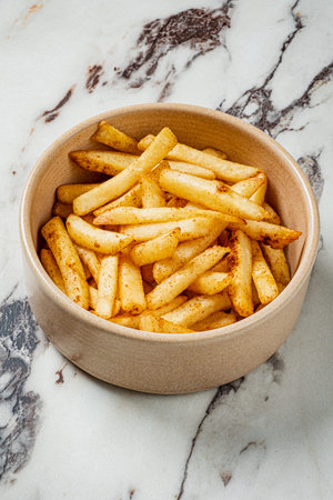 Freshly cooked fries sit invitingly in a charming bowl, ready to be enjoyed with a smile.