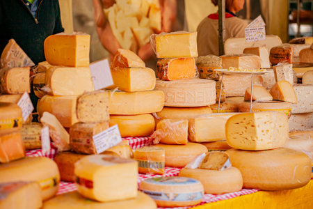 A vibrant market buzzes as vendors showcase an array of tempting, flavorful cheeses.