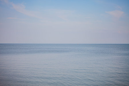 Gentle waves lap against the shore, as a soothing ambiance envelops the peaceful twilight scene.