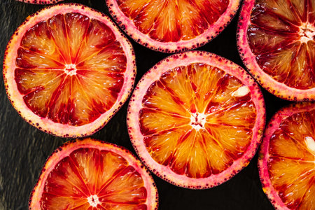 Freshly sliced blood oranges reveal vibrant hues, enticing taste and delight in each piece.