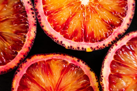 Brightly sliced blood oranges showcase their rich colors and juicy texture beautifully.