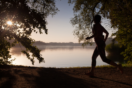 Sunset spending the woman runningの写真素材