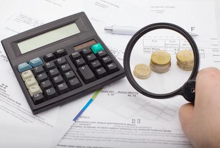 Financial accounting - searching for savings, magnifying glassの写真素材