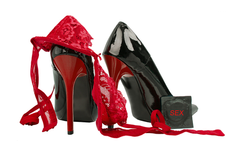Bra, condom, women's shoes isolated on a white background. High heels and Sexy underwear.の写真素材