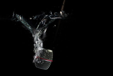 Microphone underwater - sinking mic. Professional microphone in water - concept.の写真素材