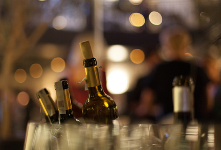 Wine bottles, glass and bokeh. Alcohol party, luxury bottles with alcohol, wine.の写真素材