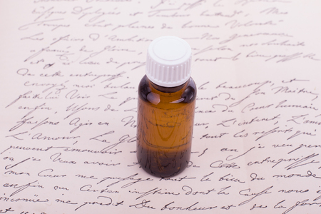 Bottle of essential oil, body care. Natural skincare, top view. Naural Remedies - Bottles and vintage text.の写真素材