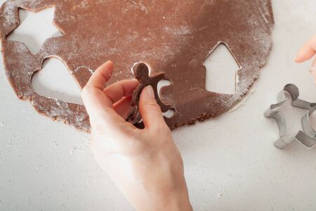 Baking Christmas gingerbread cookies in house kitchen on winter day. Christmas gingerbread cookie cutters.の写真素材