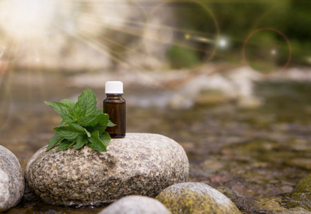 A bottle of peppermint oil on a stone.