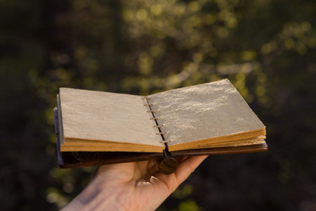 Opened old book with reflected in black surface.