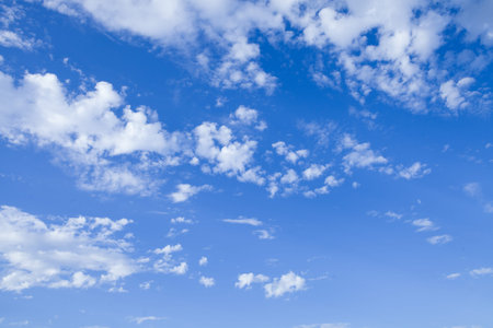 Blue sky background with tiny clouds.
