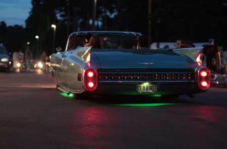 Rattvik, Sweden - July 27, 2013: Old vintage car Cadillac DeVille. Classic Car Week RÃ¤ttvik Sweden - lights on, night photo.のeditorial素材