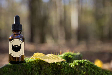 Natural beard Oil - barbershop product photography. Beard oil in amber bottle.の写真素材