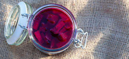 Beet sourdough in jars on a background of gray boards. Natural Medicine - banner.の写真素材