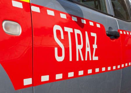 Poznan, Poland - March 26, 2021: Polish fire engine, detail - firefighters on a rescue operation.のeditorial素材