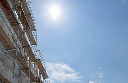 Scaffolding, metal mobile scaffold aginst blue sky background. for banner.