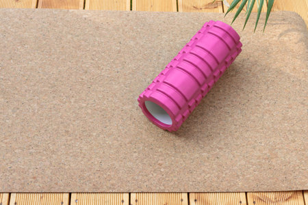 Back massage roller on yoga mat on home patio. The concept of sport and recreation. A healthy...