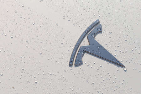 Poland, Poznan - Aug 16, 2021: Top view, Tesla Logo on Tesla Tesla Motors, Inc. is an American company that produces electric vehicles, energy storage and solar panels. Photo after rain in the sunのeditorial素材