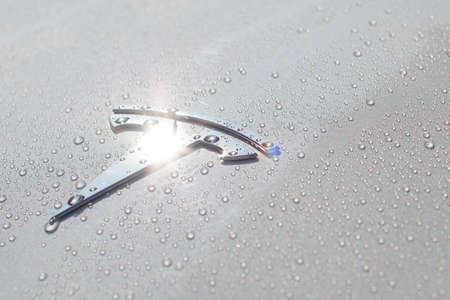 Poland, Poznan - Aug 16, 2021: Shining Tesla Logo on Tesla Tesla Motors, Inc. is an American company that produces electric vehicles, energy storage and solar panels. Photo after rain in the sunのeditorial素材
