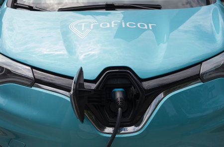 Warsaw, Poland - June 05.2021: Traficar is car sharing company, electric cars charging on street. Close-up carsharing car RENOのeditorial素材