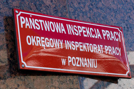 Poznan, Poland - March 24, 2020: Logo and sign of National Labor Inspectorate (Polish: State Labor Inspectorate).のeditorial素材