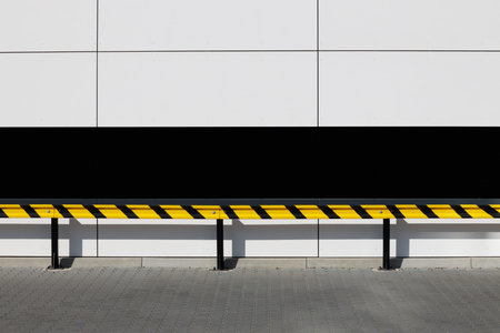 Safety barriers in a chewed up color in the parking lot. Protecting building walls from damage.