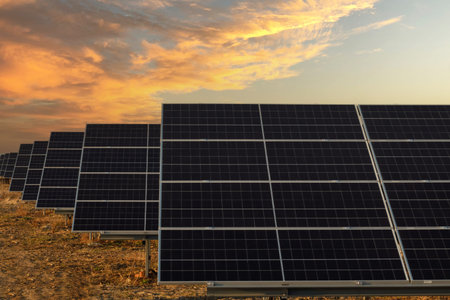 Pannele solar with full power on farm. Photovoltaic power generation, sunset. Trench