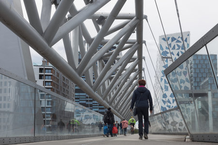 Oslo, Norway. May 02, 2022: Pedestrian bridge in Oslo, Norway. View of urban architecture. A group of pedestriansのeditorial素材