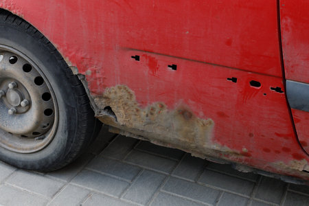 Corroded vehicle, damaged car body. Close-up photo of element rusty car.の写真素材
