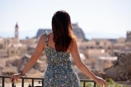 Back view of woman and looking at Corfu town in Greece. City break, conceptual image.