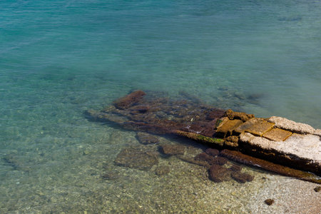 Bathing in Corfu town, blue water. In the background, a mountain range.の写真素材