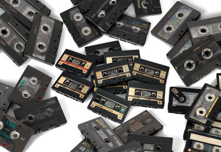 Poznan, Poland - February 16, 2023 Old cassette tapes on a table.Top view close up photography.