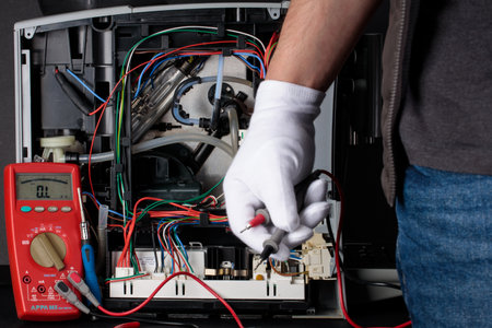 The serviceman during the repair of the coffee machine tests and checks the coffee brewing device.のeditorial素材