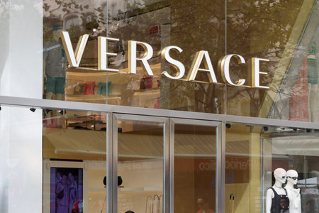 Exterior view of the Versace store in Barcelona showcasing its iconic logo. Versace is a prestigious...