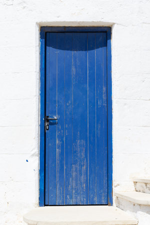 Rustic Blue Door on White Wall.の写真素材