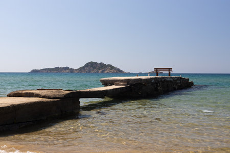 Seaside Pier with Bench and Island Viewの写真素材