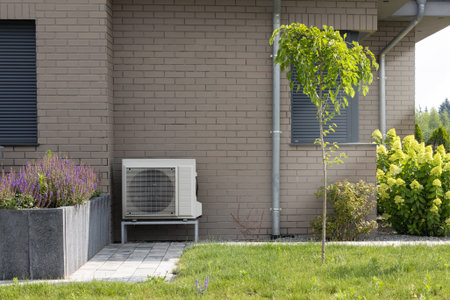 Outdoor Heat Pump on Brick Wall Backgroundの写真素材