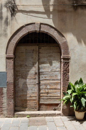 Old Wooden Door with Archway in Historic Cityの写真素材