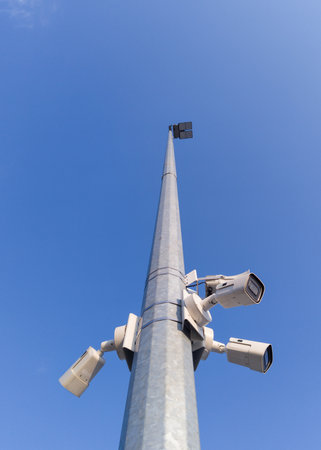 Security Cameras Mounted on Tall Poleの写真素材