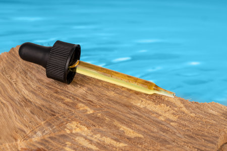 Essential Oil Dropper on Driftwoodの写真素材