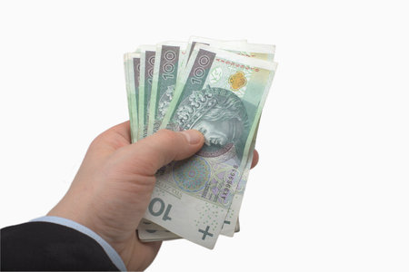 Hand Holding Stack of Polish 100 Zloty Banknotesの写真素材