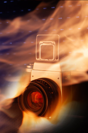 Abstract photo of a vintage camera surrounded by flames, blending art and technology.の写真素材