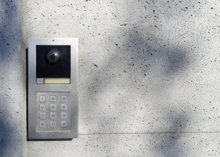 Metal intercom with keypad on concrete wallの写真素材