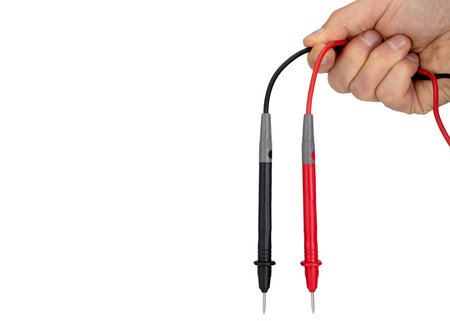 Hand Holding Red and Black Multimeter Probes